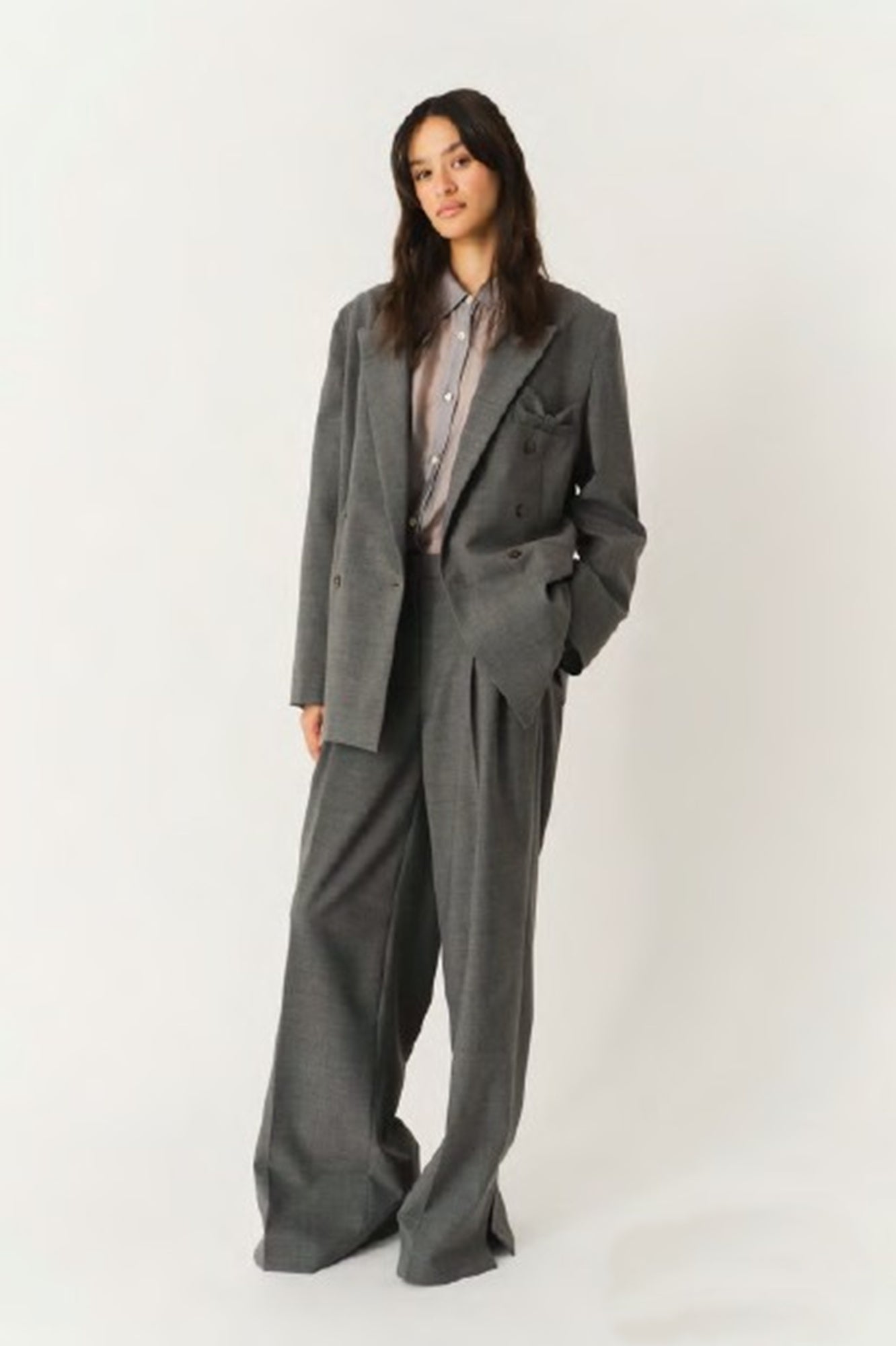 Person wearing a gray suit on a white background