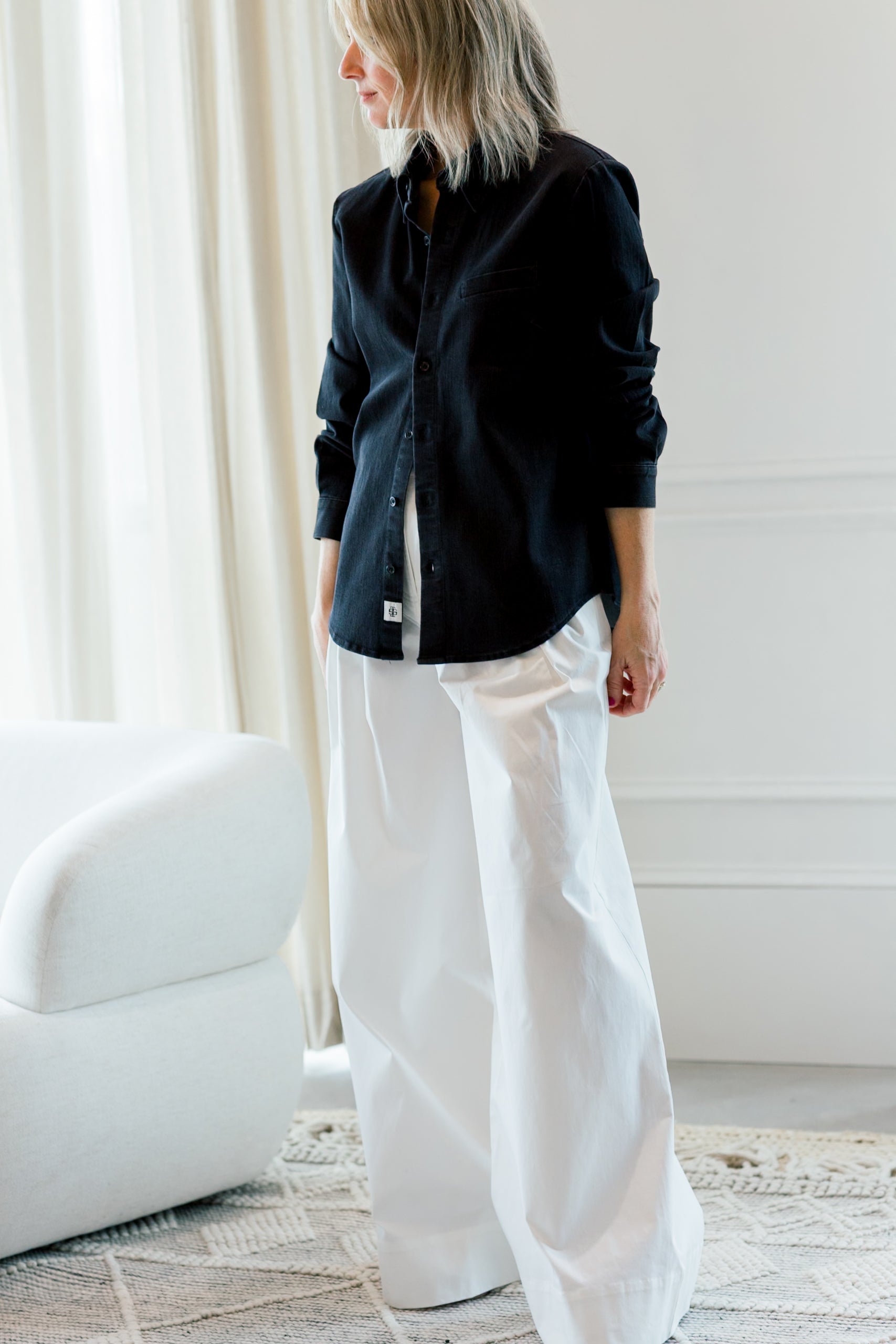 image of a woman wearing the garment merci placket shirt
