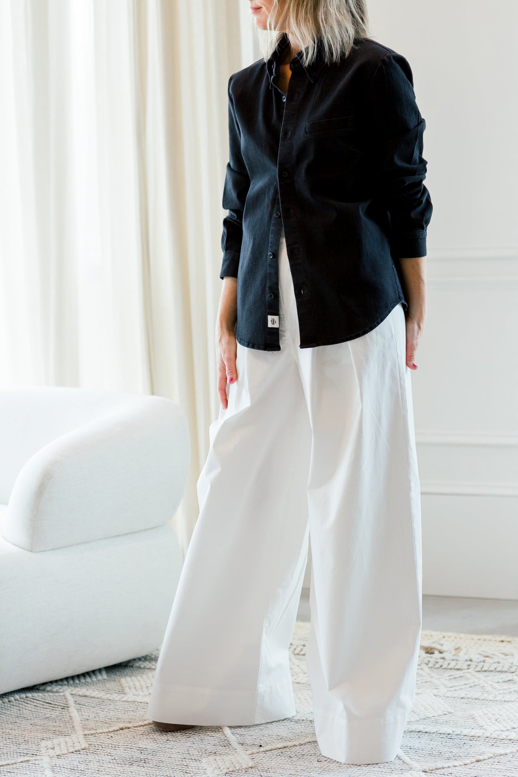 image of a woman wearing the garment merci placket shirt and avelino pants