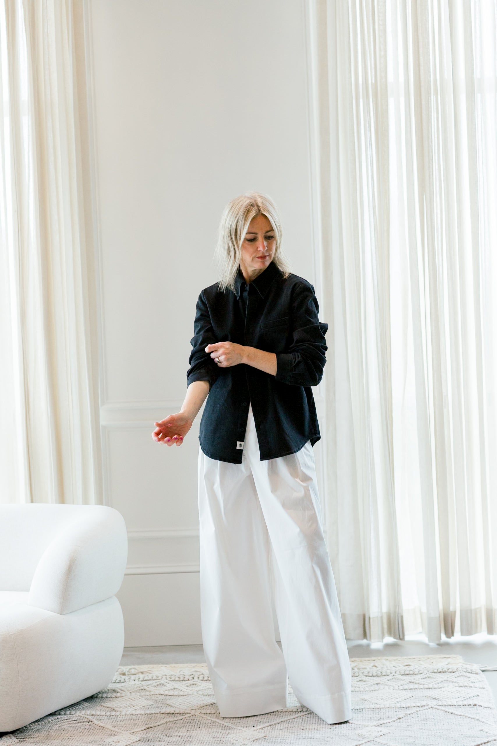 image of a woman wearing the garment merci placket shirt and avelino pants