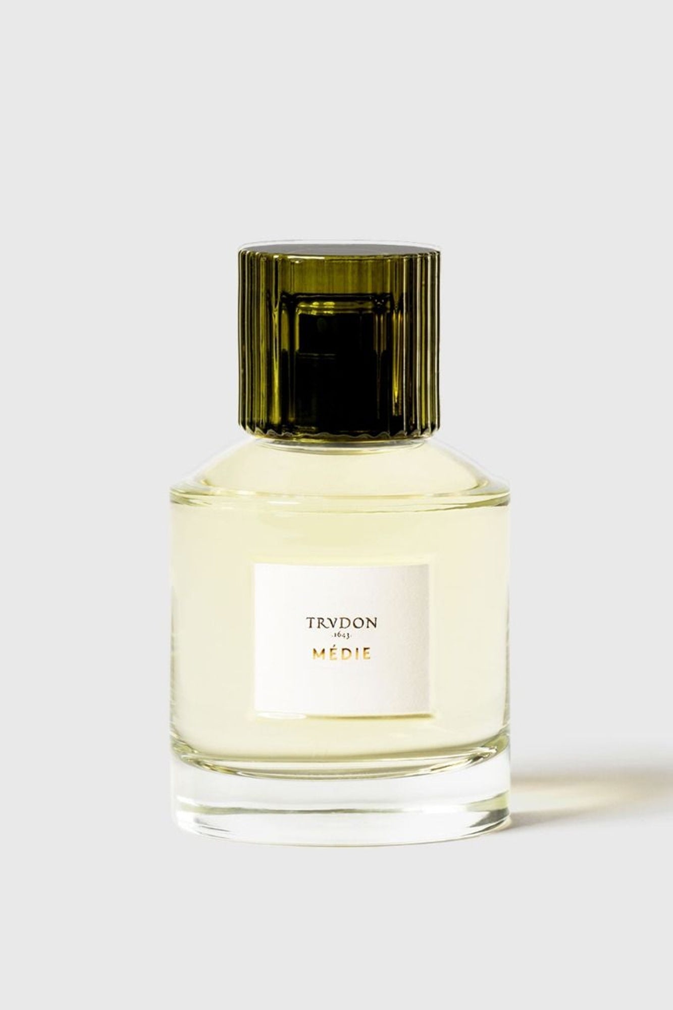 Perfume bottle with green cap on a white background